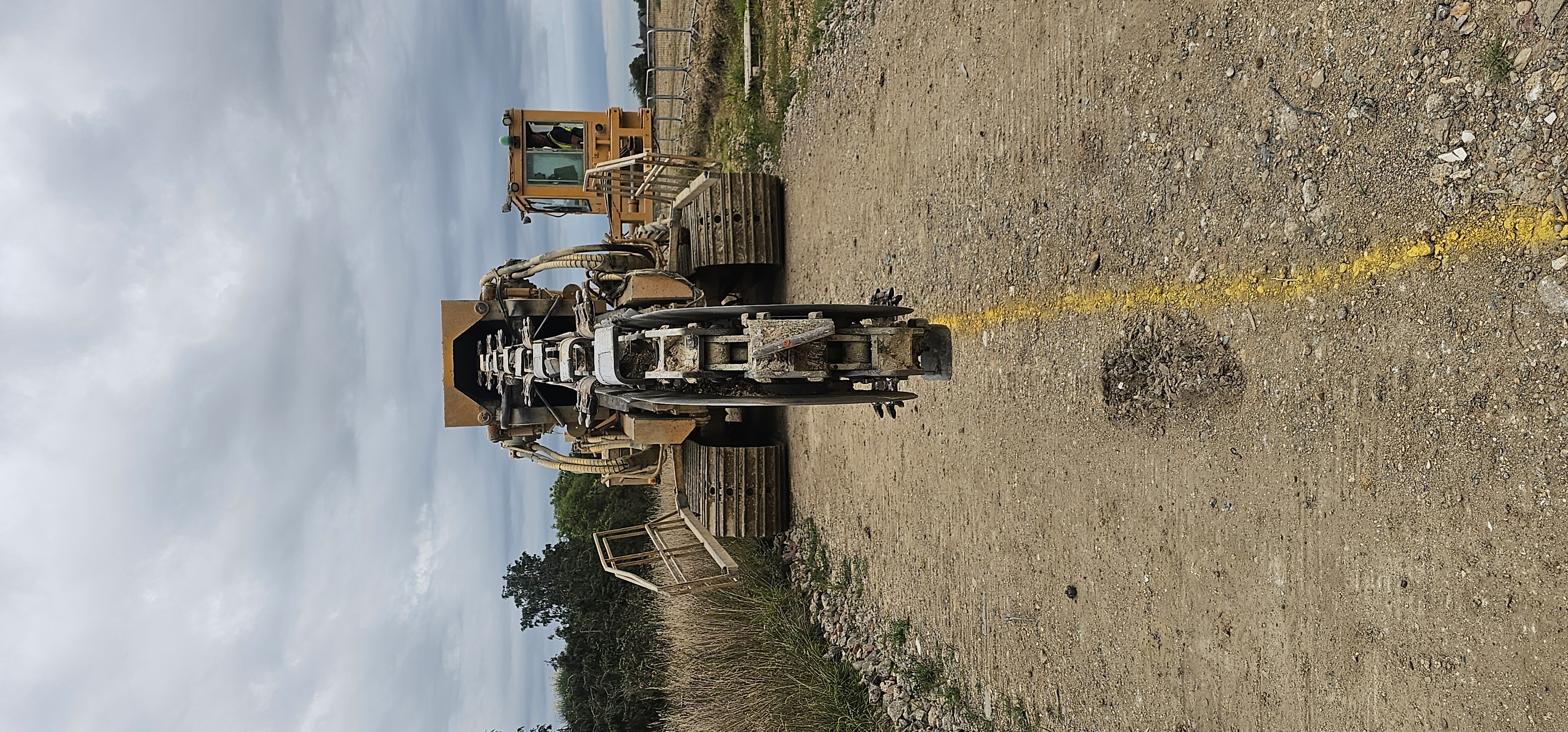 Trencher with carbide teeth cutting stabilised ground wall